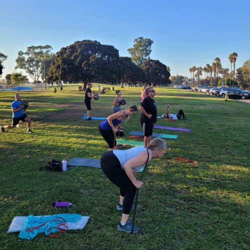Outdoor fitness classes San Diego for adults 40–65 training at Mission Bay Park.