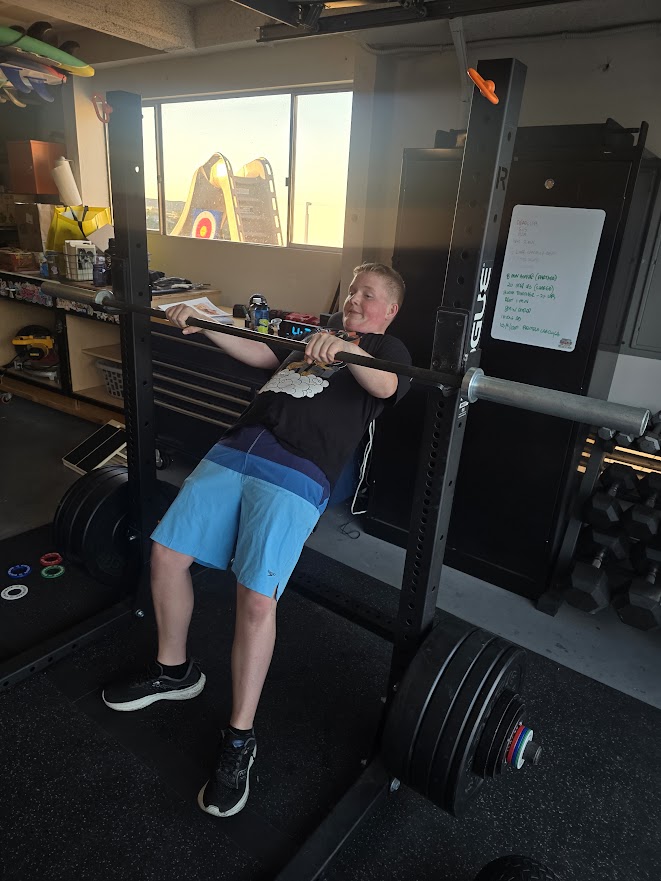 autistic child performing supervised strength exercises with a professional trainer