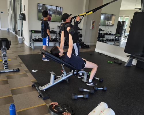 autistic youth performing supervised strength training exercises in a calm gym environment